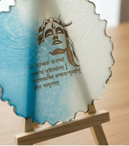 Decorative plate with a face design and text on a stand