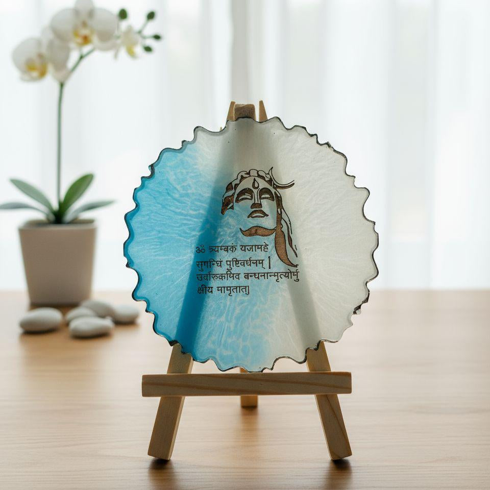 Decorative plate with a face design on a wooden stand, placed on a table with a blurred background.